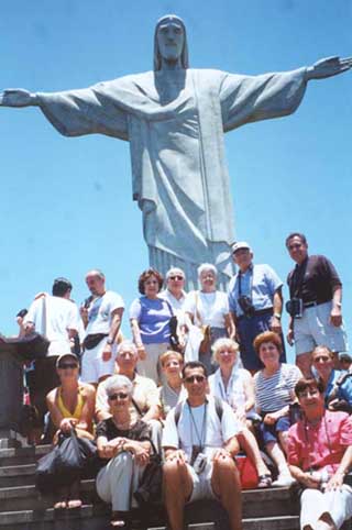 Some members of the 32-member Armenian Group Tour to South America, organized by AR Travel, the travel affiliate of the Armenian Reporter Int'l, pose at the foot of Christ the Redeemer statue on top of Corcovado Mountain in Rio de Janeiro, Brazil. At a height of over 2,100 feet, it offers a sweeping view of the area below. The group traveled from Rio to Sao Paulo, Iguassu Falls and Buenos Aires, before returning home Thanksgiving morning from Montevideo, Uruguay.