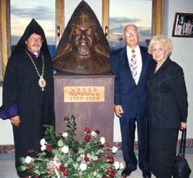 Archbishop Mesrob Ashjian and Mr. & Mrs. Vartkes Markarian next the bust of Karek