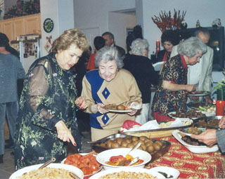 Hostess Virginia Matossian serves Zevart Bozajian