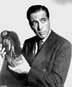 The legendary actor, Humphrey Bogart, displays the falcon that 'dreams are made of' in a publicity shot for his classic movie, 'The Maltese Falcon'